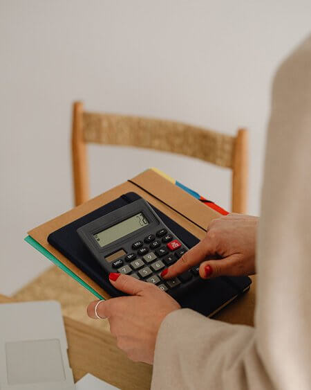 Image of female bookkeeping professional using a calculator.