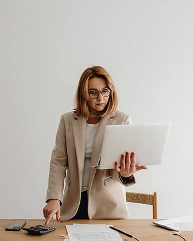 Image of female bookkeeping professional standing by desk