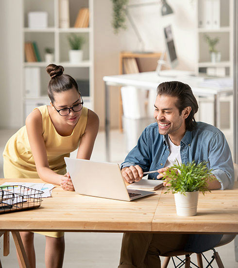 Image of QuickBooks Payroll Processing male and female sitting at a tab